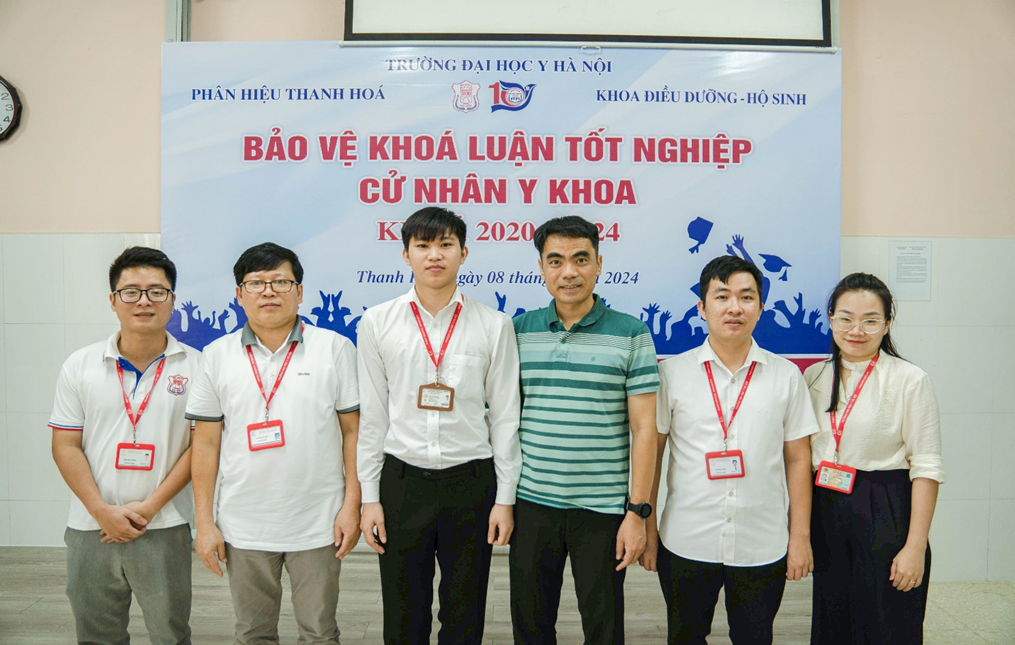 A group of men standing in front of a banner

Description automatically generated